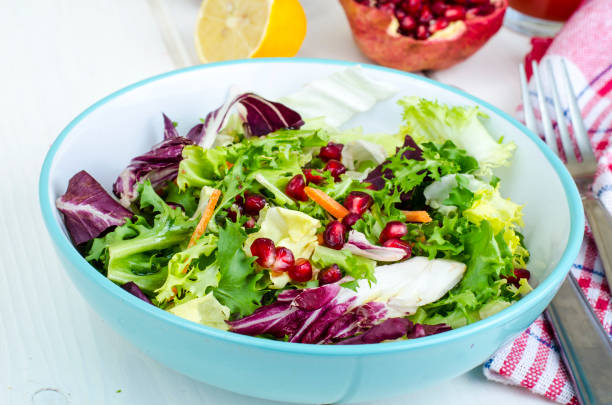istock Fresh green salad with pomegranate, vegetarian menu 1081866792