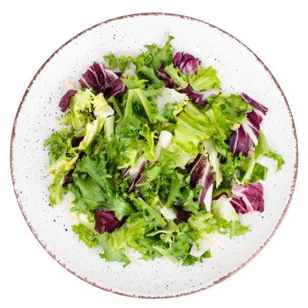 istock Plate with fresh lettuce leaves isolated on white background 1081866800