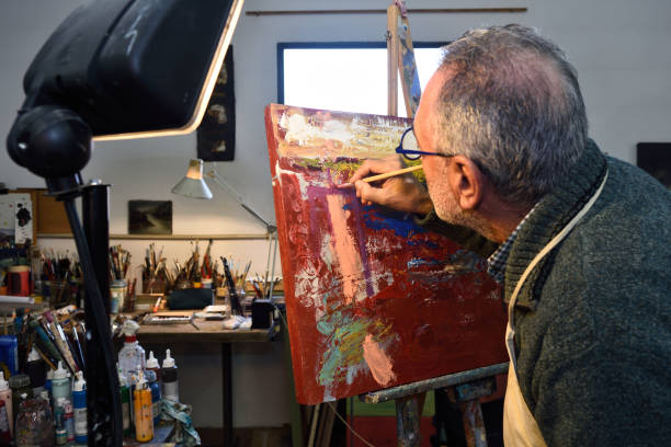 istock Painter artist painting a picture in the studio 1081868842