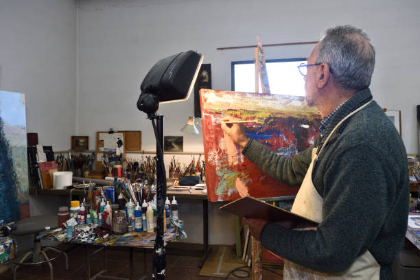 istock Painter artist painting a picture in the studio 1081868862