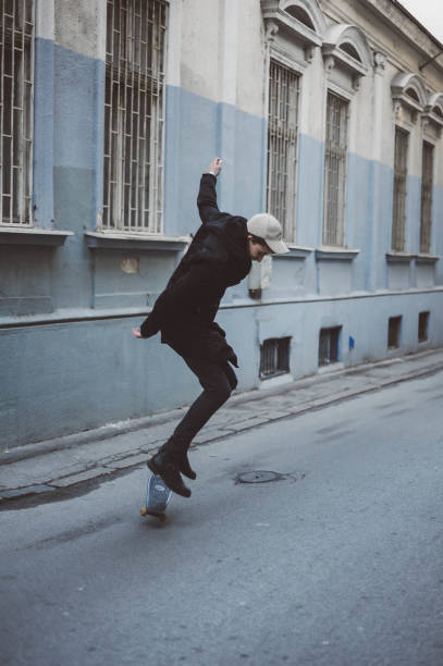istock Young man skateboarding on the street 1081871440