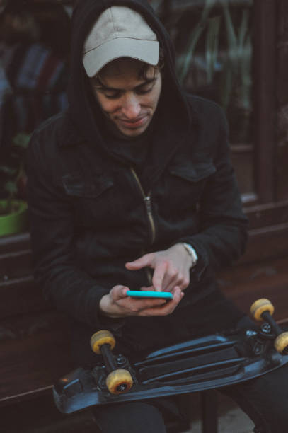 istock Young skater man using mobile phone outdoors 1081871514
