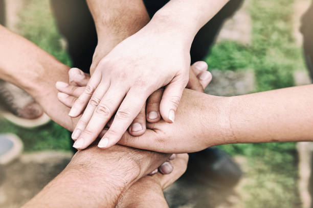 istock The abstract art design background of human hands touching together,teamwork concept,blurry light around 1081871742