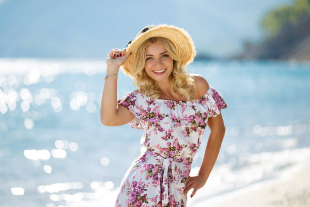 Young woman on beach with sun dress Young woman on beach with sun dress sundress stock pictures, royalty-free photos & images