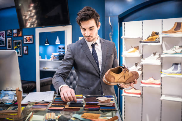 istock Shoe shop owner arranging leather samples 1081874934