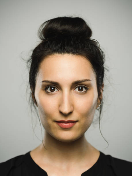 Real mediterranean young woman with blank expression