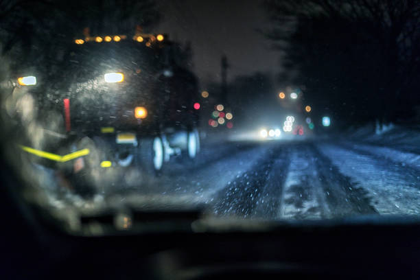istock Abstract Passing Snow Plow Truck During Winter Blizzard Snow Storm 1081880542