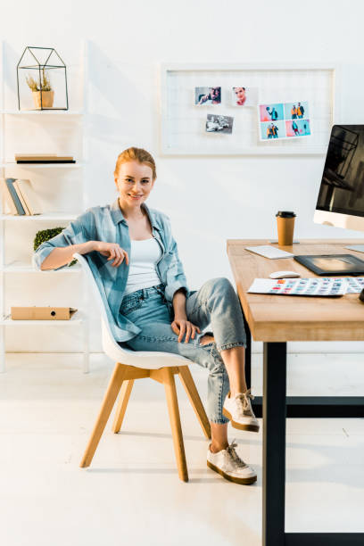 istock beautiful young retoucher smiling at camera while sitting at workplace 1081881364