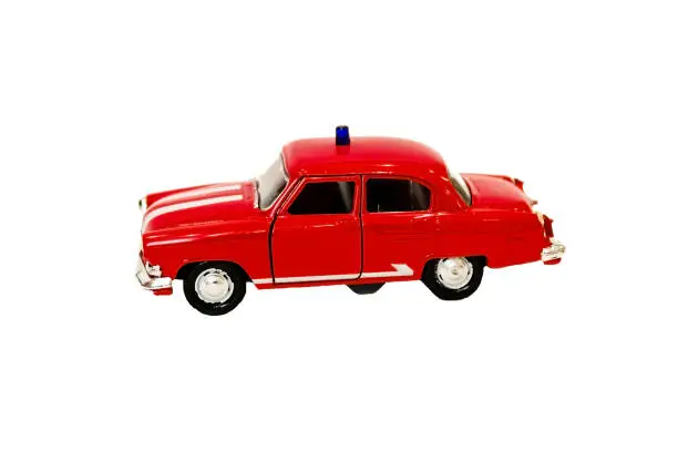 Photo of beautiful little red toy car on a white background