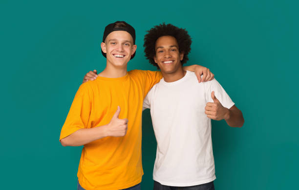 istock Diverse teens showing thumbs up over blue background 1081888966