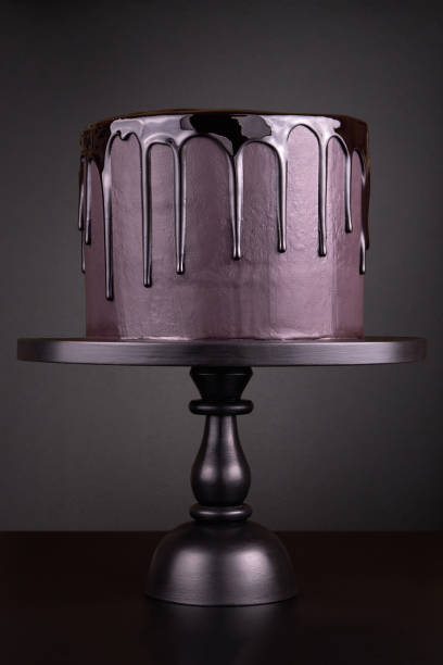 istock Chocolate cake with black glaze on a black background. 1081889896