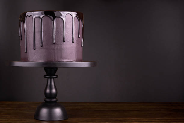 istock Chocolate cake with black glaze on a black background. 1081889906