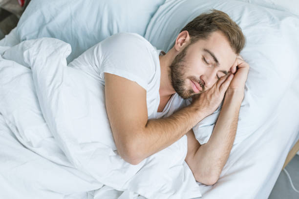 istock high angle view of handsome young man sleeping in bed 1081891476