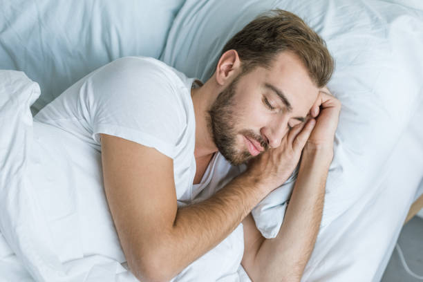 istock high angle view of handsome bearded young man sleeping in bed 1081891478