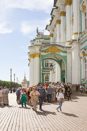 Tourists standing in a long queue to the State Hermitage museum in Saint-Petersburg, Russia, vertical