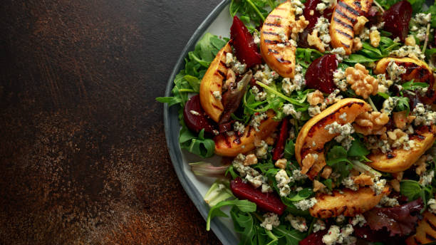 istock Grilled quince salad with baked and fresh grated beetroot, blue cheese, walnuts on rustic table 1081892658