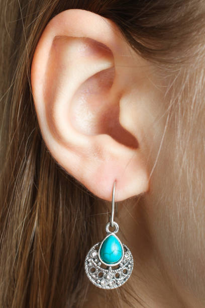 istock Ear with a beautiful earring with a turquoise stone 1081897298