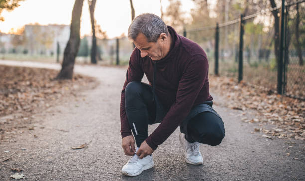 istock Senior man tying his shoelace 1081904358