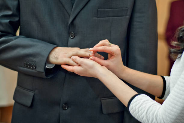 istock Wedding ceremony. The brides hold each other hands. Clothes ring on a finger. 1081905602