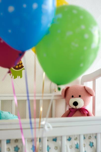 istock Balloons, baby bed and toy 1081905900