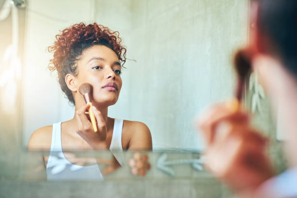 ajoutant une lueur - applying make up flash photos et images de collection