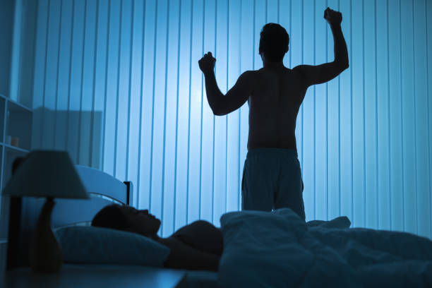 istock The man doing exercise near a sleeping woman. night time 1081906652