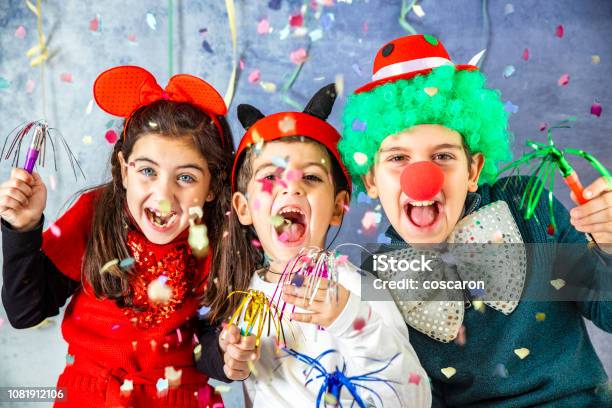 Three Kids Celebrating Carnival Together At Home Stock Photo - Download Image Now - Carnival - Celebration Event, Child, Costume