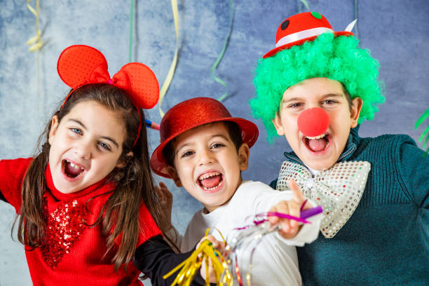 istock Three kids celebrating Carnival or New Years Eve 1081912108