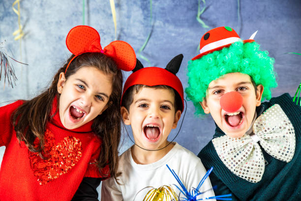 istock Three kids celebrating Carnival or New Years Eve 1081912118