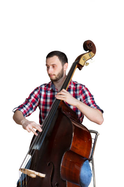11 year old boy in tuxedo playing the Double Bass.  Isolated on white.