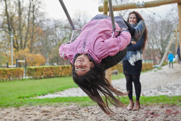 istock Girl on the swing smiling 1081920674