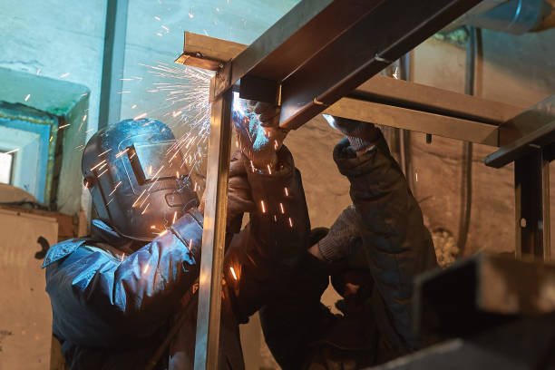 istock welder welds a metal frame for the power plant. 1081922464