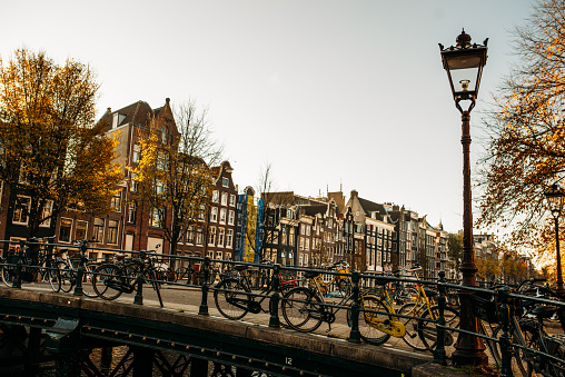Streets of Amsterdam, famous bridges, bicycles and architecture in iconic European city in Netherlands