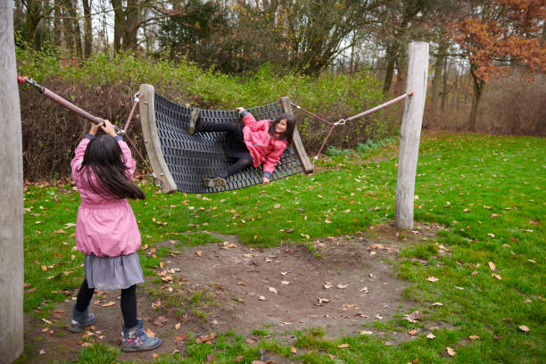 Pakistan immigrants in Denmark. Family living in Horsens, Jutland. Two sisters at the playing ground.