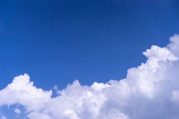 istock white fluffy cloud on bright blue sky with copy space on sky 1081923162