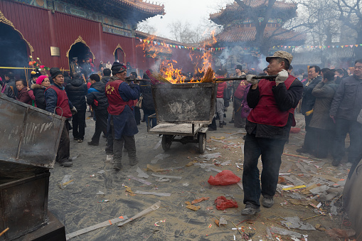 Chinese New Year celebrations in Yonghegong temple, Beijing. Incense burning and prayers are the main activities that take place in the temples across China on this special day. In recent years the act of lighting incense has been greatly reduced as the awareness of the pollution caused from it has become a great concern. The greatest risk to health is for the cleaners who keep the temples in order and prevent the fire and smoke getting out of control.