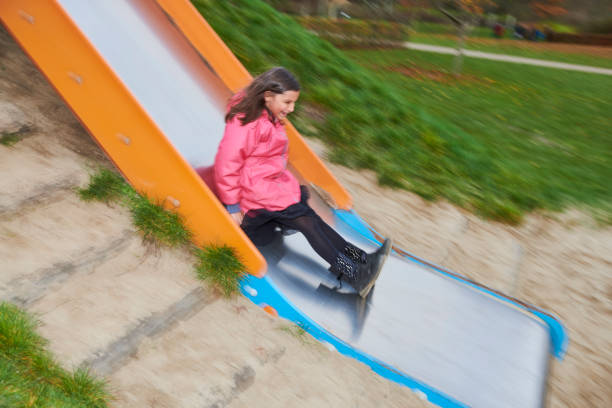 Pakistan immigrants in Denmark. Family living in Horsens, Jutland. The daughter at the playground, sliding on the slide.