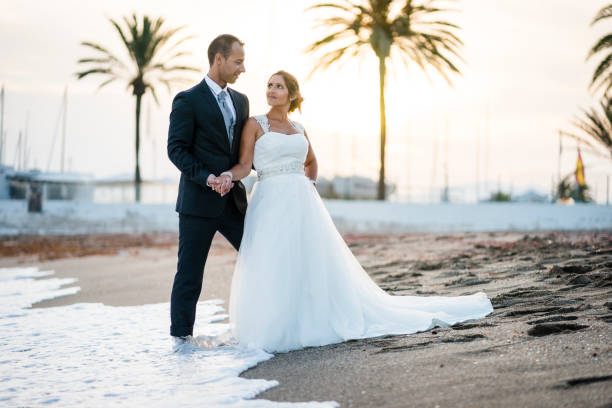 istock Newlywed couple hugging each other on the beach 1081926124