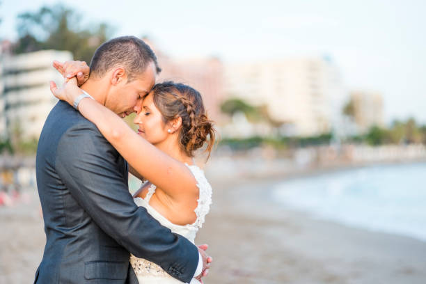 istock Newlywed couple hugging each other on the beach 1081926200