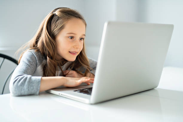 istock A Young girl using laptop at home 1081926648