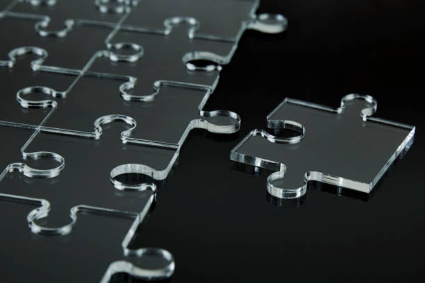 istock abstract puzzle pieces on black background 1081926776