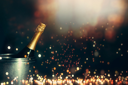 New Year 2019 Celebration Concept. Bottle of champagne on a background of holiday lights