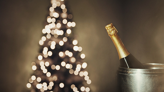 New Year 2019 Celebration Concept. Bottle of champagne on a background of holiday lights