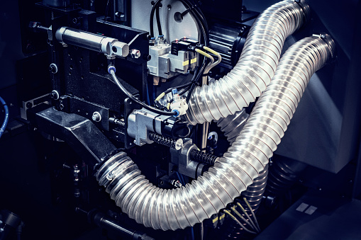 Flexible reinforced plastic hoses on a machine