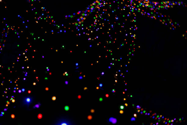 istock Abstract led lights in multi colors attached to huge tree at night makes a unique background for holiday party 1081945040