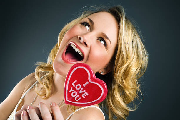 istock Young Woman Holding Heart Shaped Lollipop 108194579