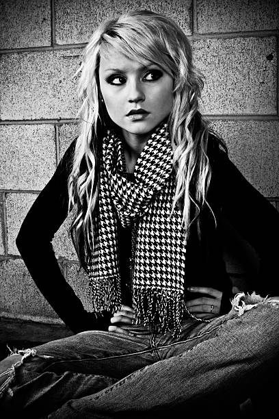 istock Young Woman Sitting Down Against Brick Wall, Black and White 108194582