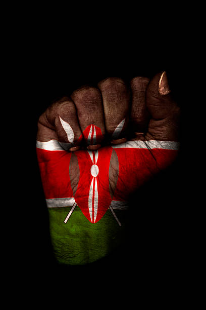 Clenched Fist with Kenyan Flag Painted, Isolated on Black stock photo
