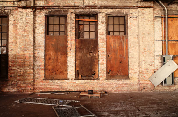 Boarded up windows in an abandoned factory.  