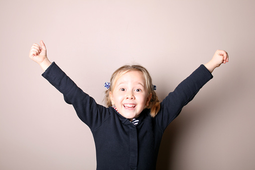 Joyful little girl on a white background.